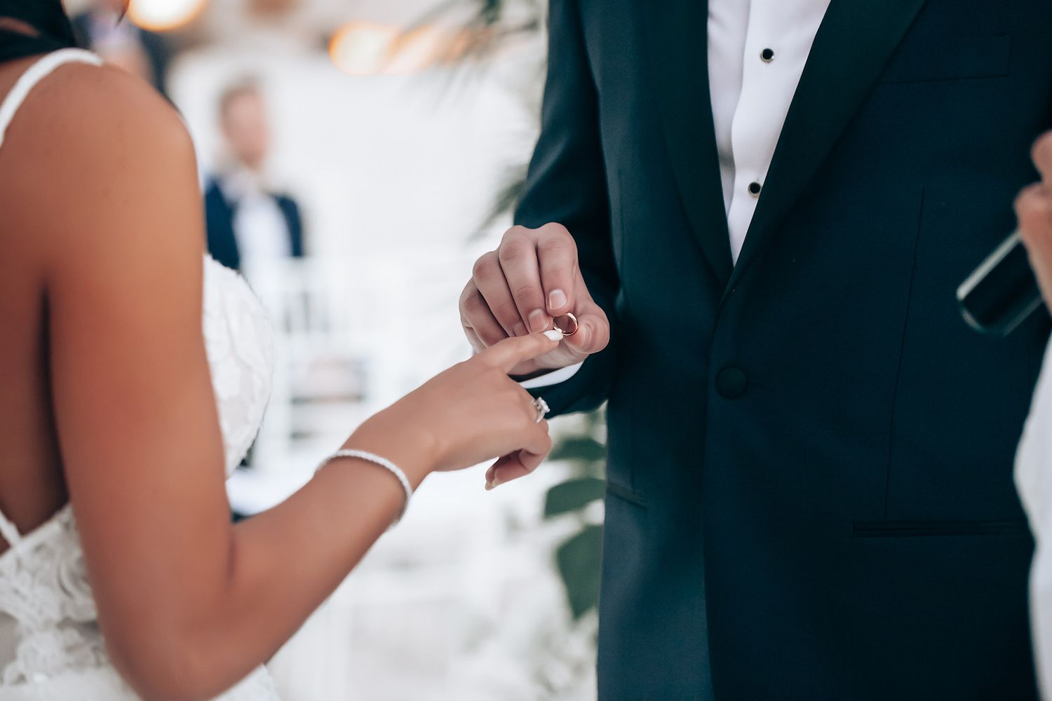Elegant wedding reception with guests in formal black tie attire.