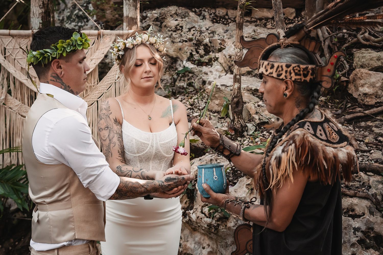 Couple exchanging vows with officiant in leopard print during rustic outdoor wedding ceremony.