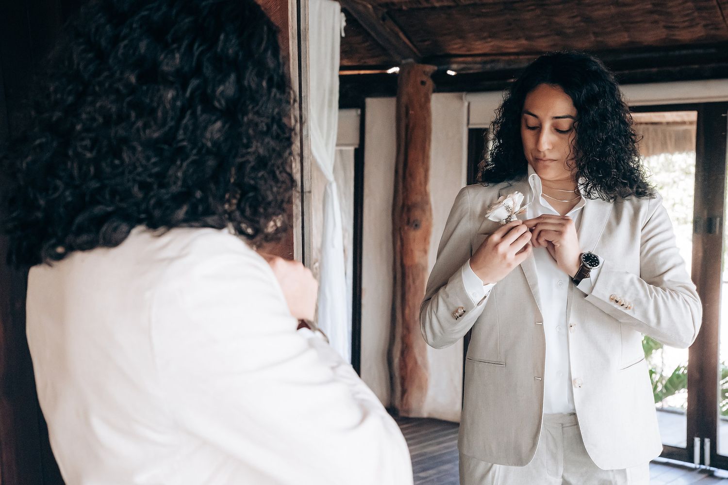 Multiple shots of a person with natural curly hair wearing white clothing in an indoor setting.