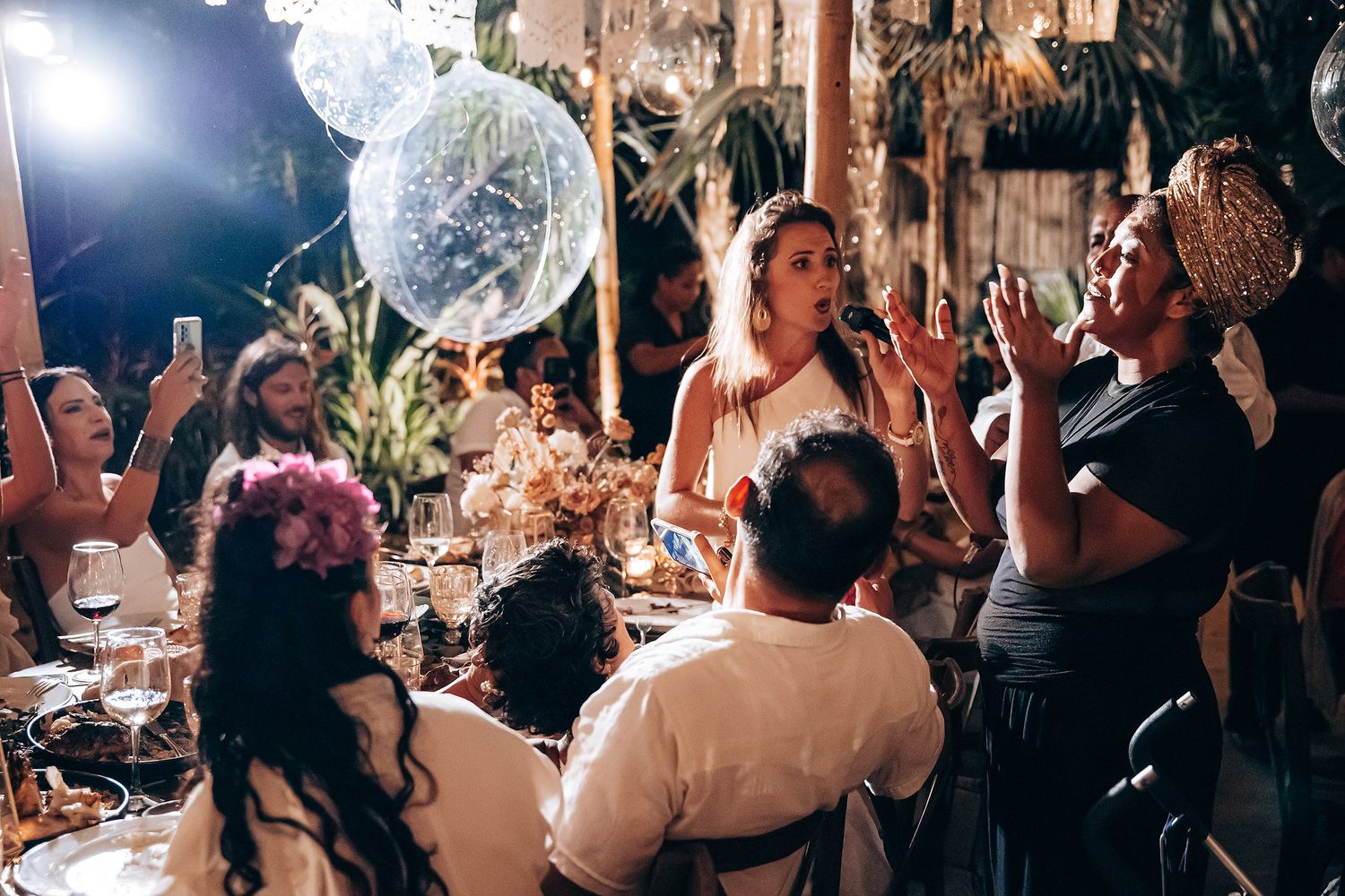 Lively nighttime party scene with disco balls and dancing guests enjoying an indoor celebration.