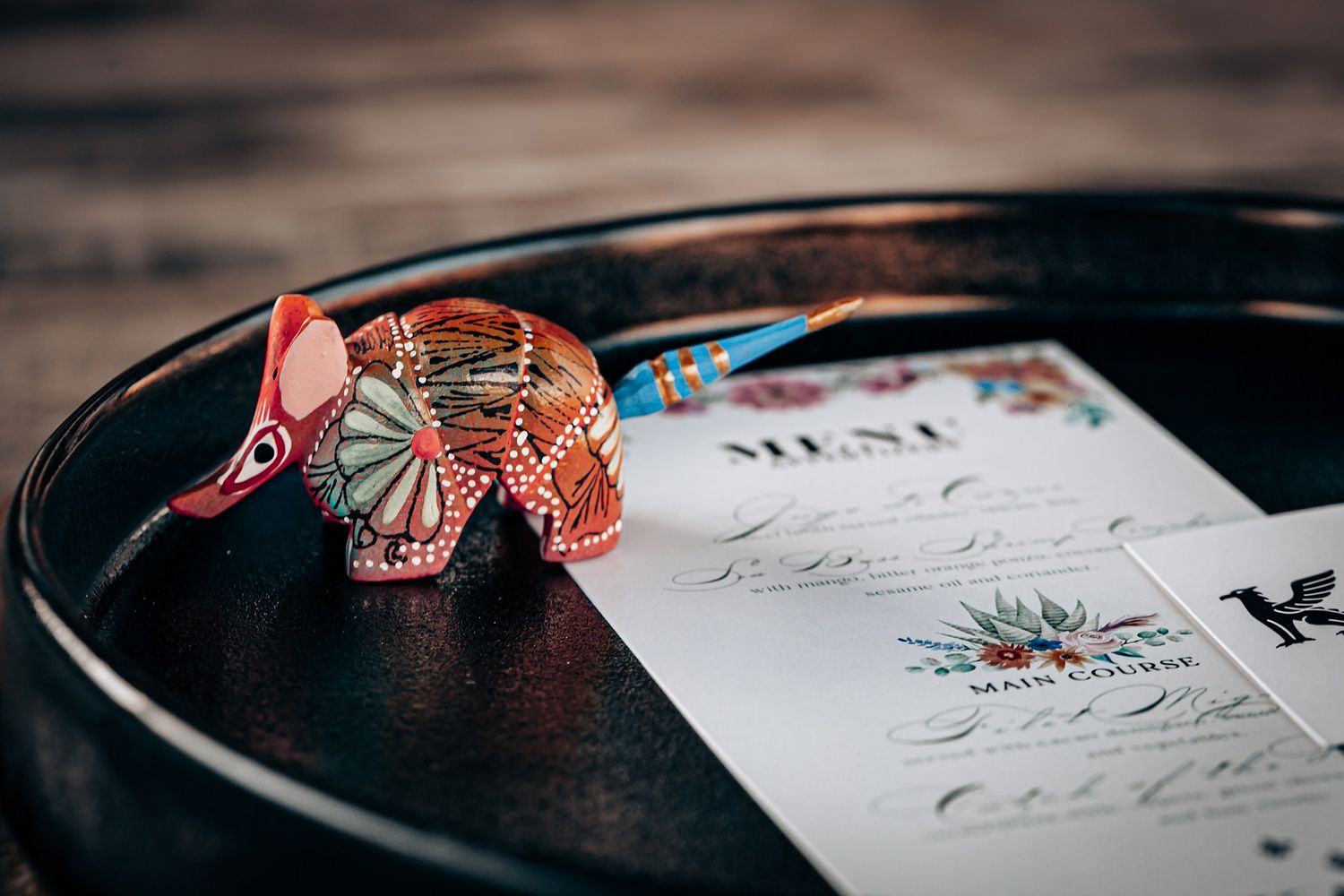 Close-up view of paper origami butterflies resting on a written document with elegant calligraphy.
