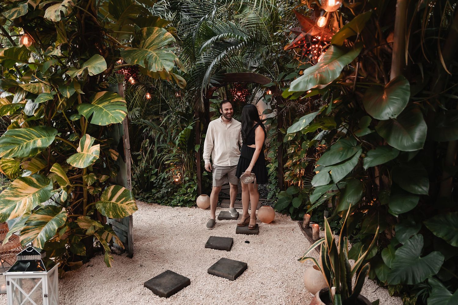 Photographers capturing moments in a lush tropical garden setting.