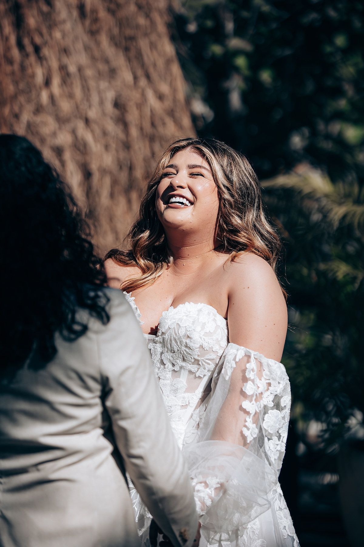 A joyful moment captured during a wedding celebration outdoors.