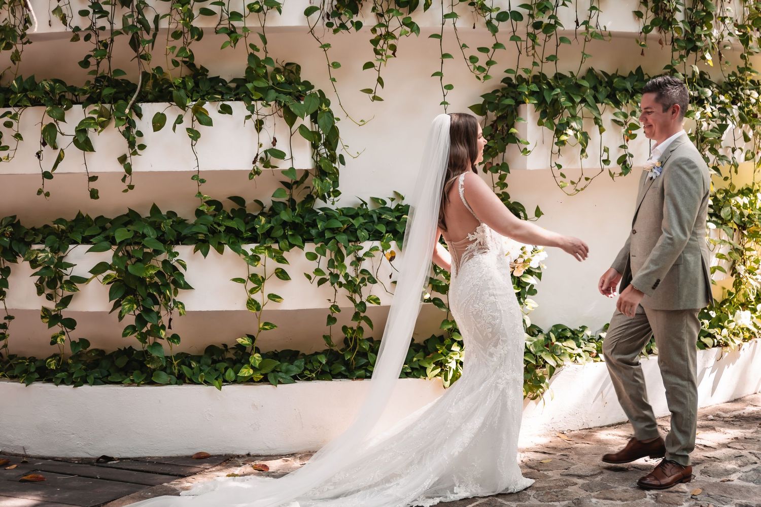 Elegant bridal portraits under climbing vines and natural lighting on a stone patio.