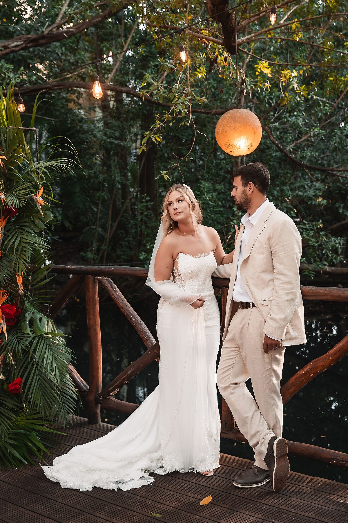 Elegant outdoor wedding scene with string lights and paper lanterns creating a romantic atmosphere.