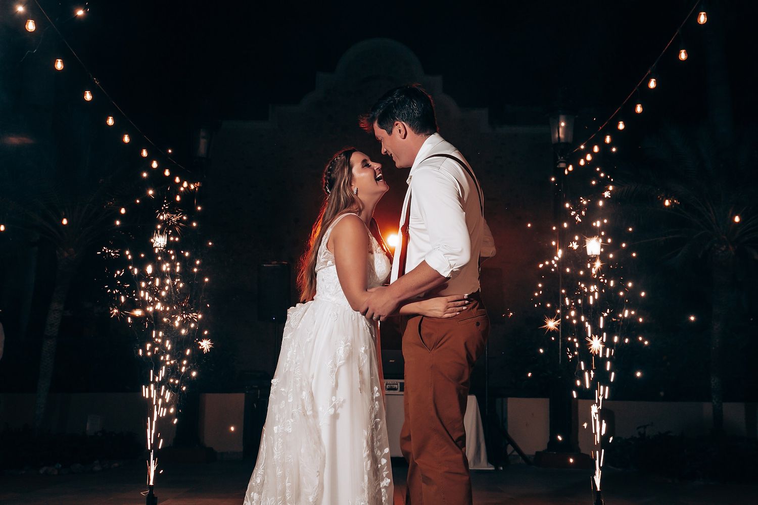 Romantic nighttime wedding dance with string lights creating magical ambiance.