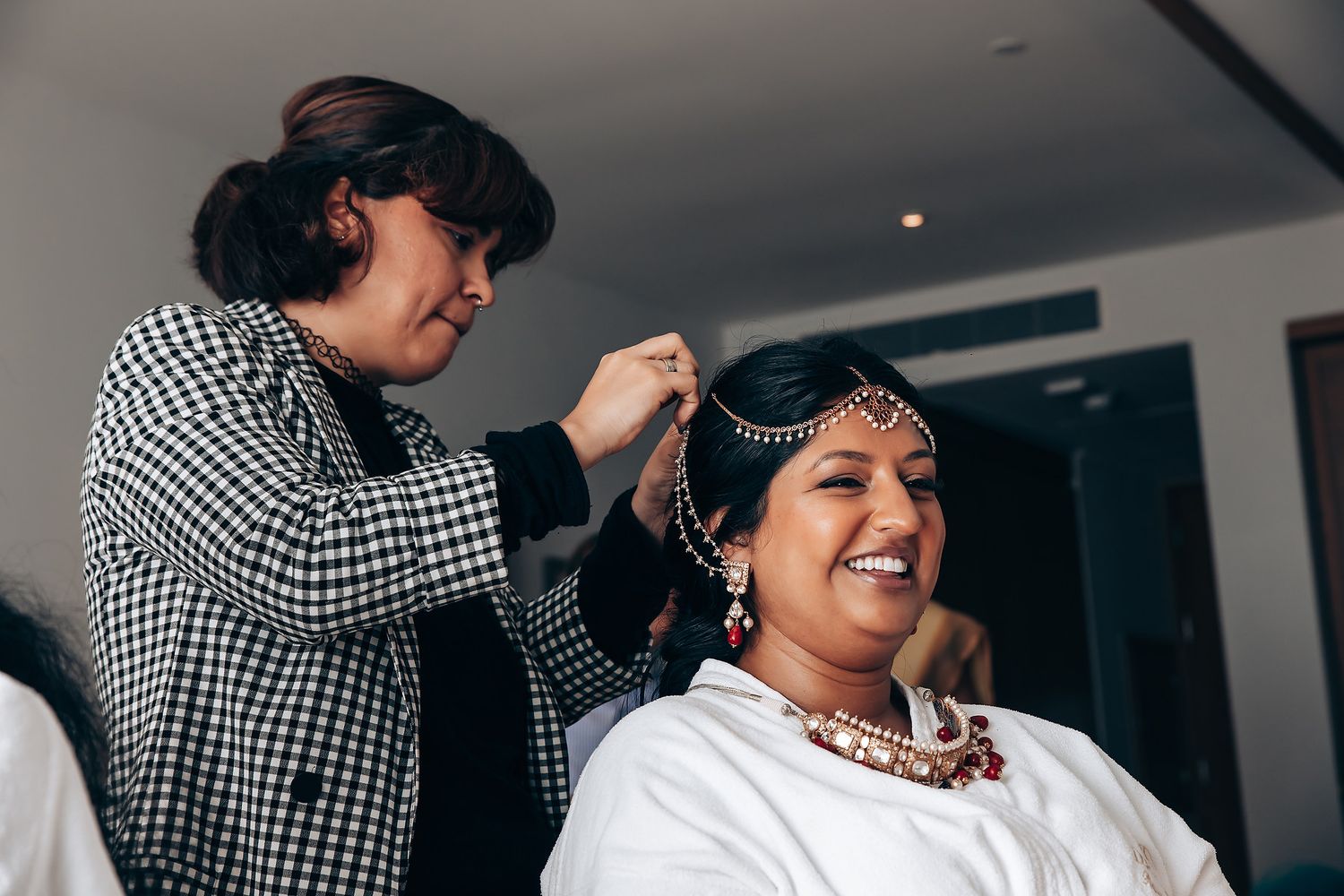 Getting ready scene with traditional Indian bridal preparations and jewelry.