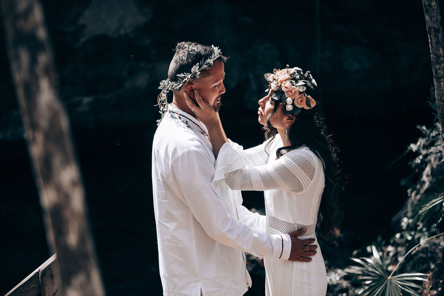 A mystical ritual ceremony being conducted among trees with participants in white attire.