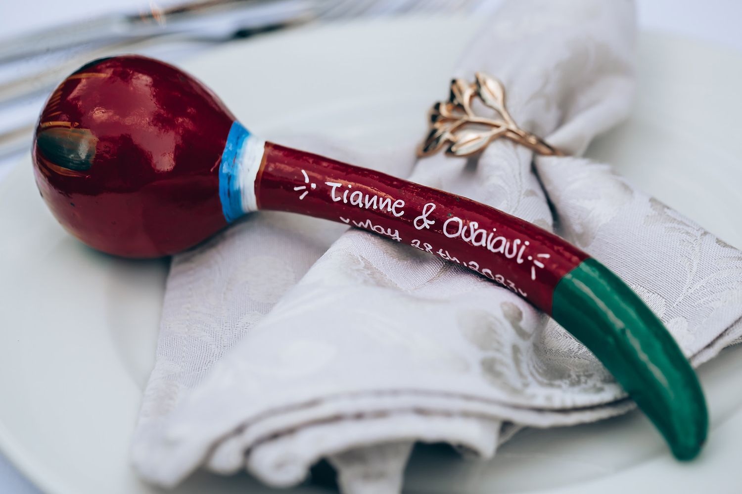Wedding detail shot of decorative elements in burgundy and white colors.