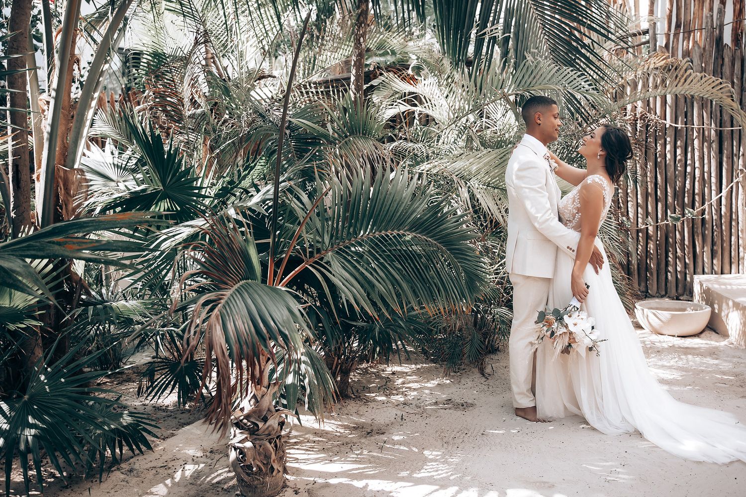 Tropical garden wedding photoshoot with palm trees and natural lighting.