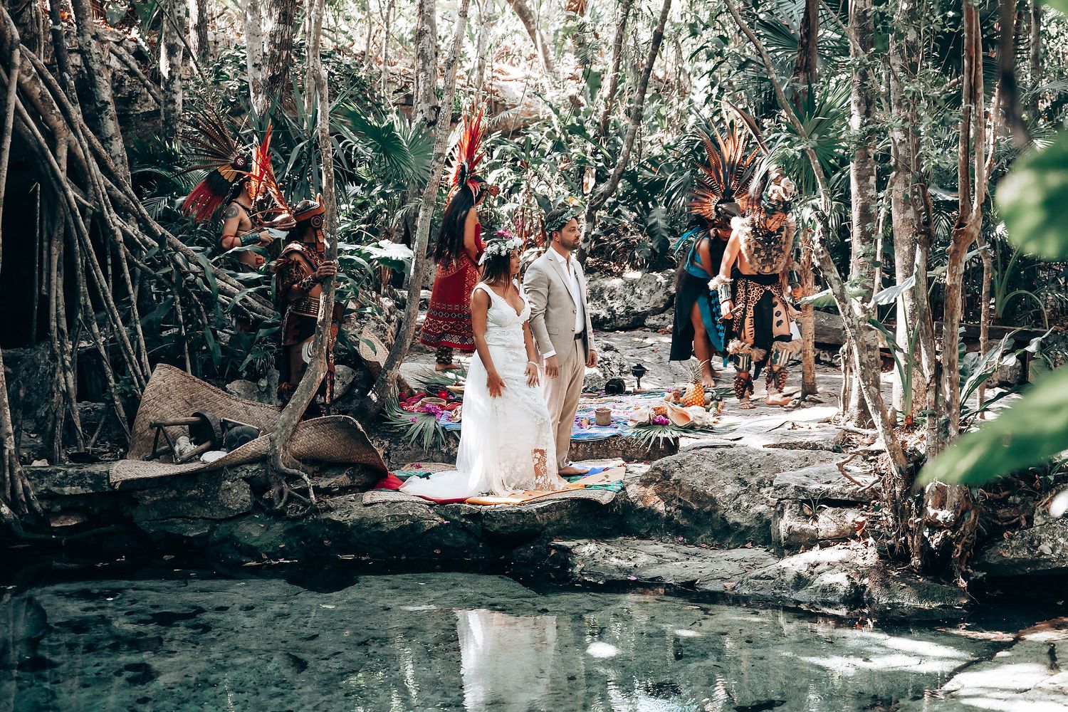 Natural forest wedding venue with dappled sunlight streaming through tree canopy.