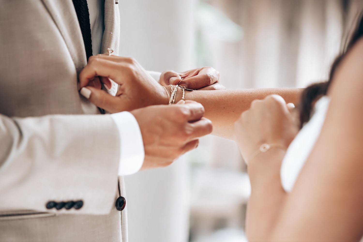 Close-up of a couple toasting with champagne glasses during an intimate celebration.