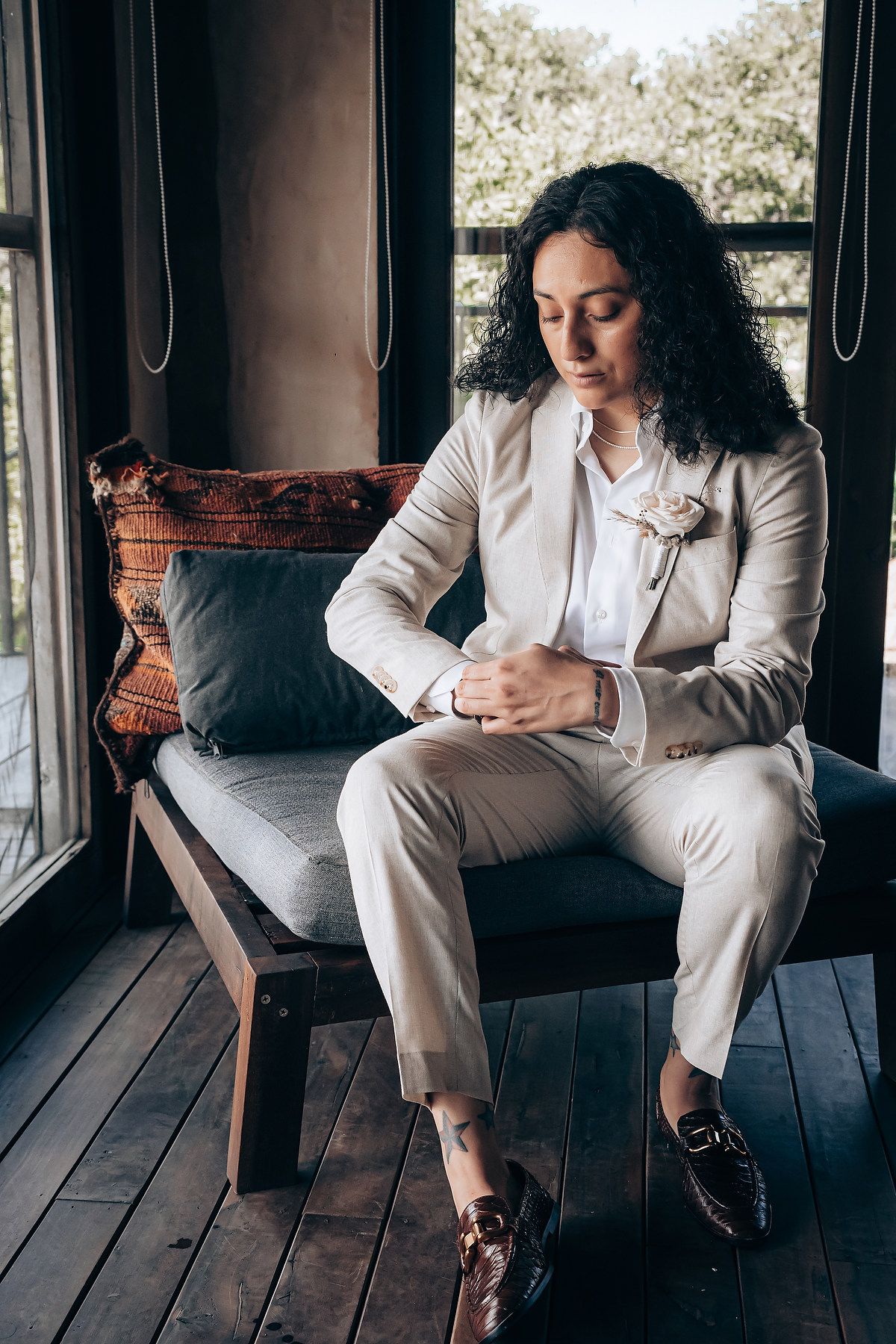 A series of contemplative poses in a white suit against a wooden deck background.