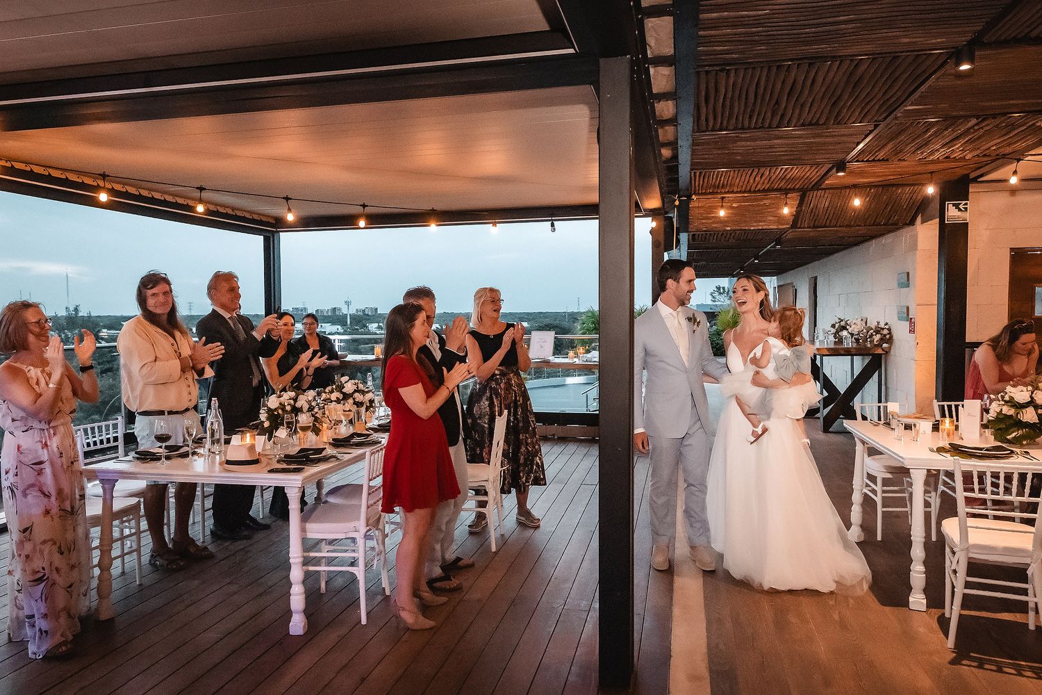Wedding reception celebration in modern coastal venue with panoramic ocean views.