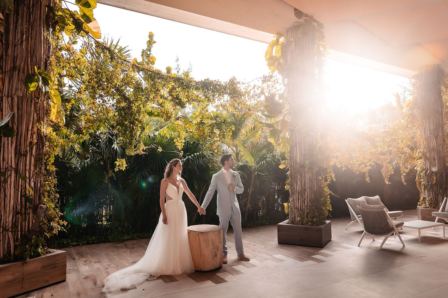 Golden sunlight streams through tropical foliage creating a romantic garden atmosphere.