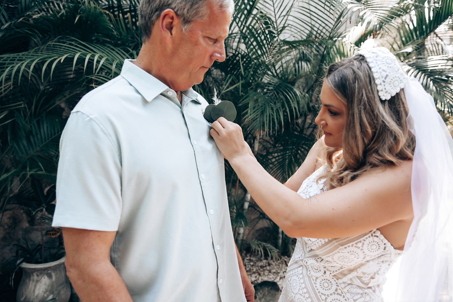Bride and groom share intimate moments in a garden setting during their wedding photo session.