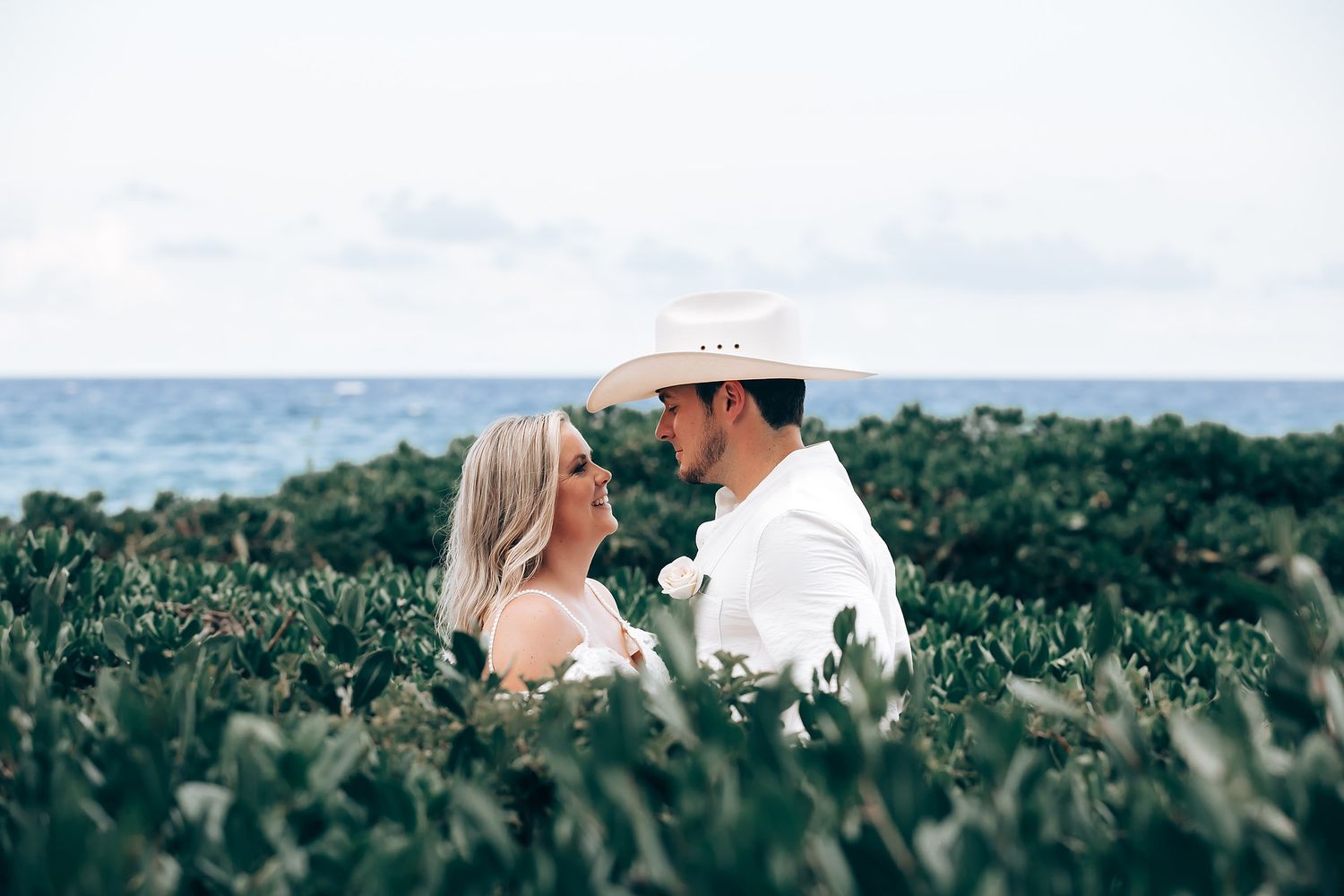 Romantic dance sequence photographed against an ocean horizon with palm trees.
