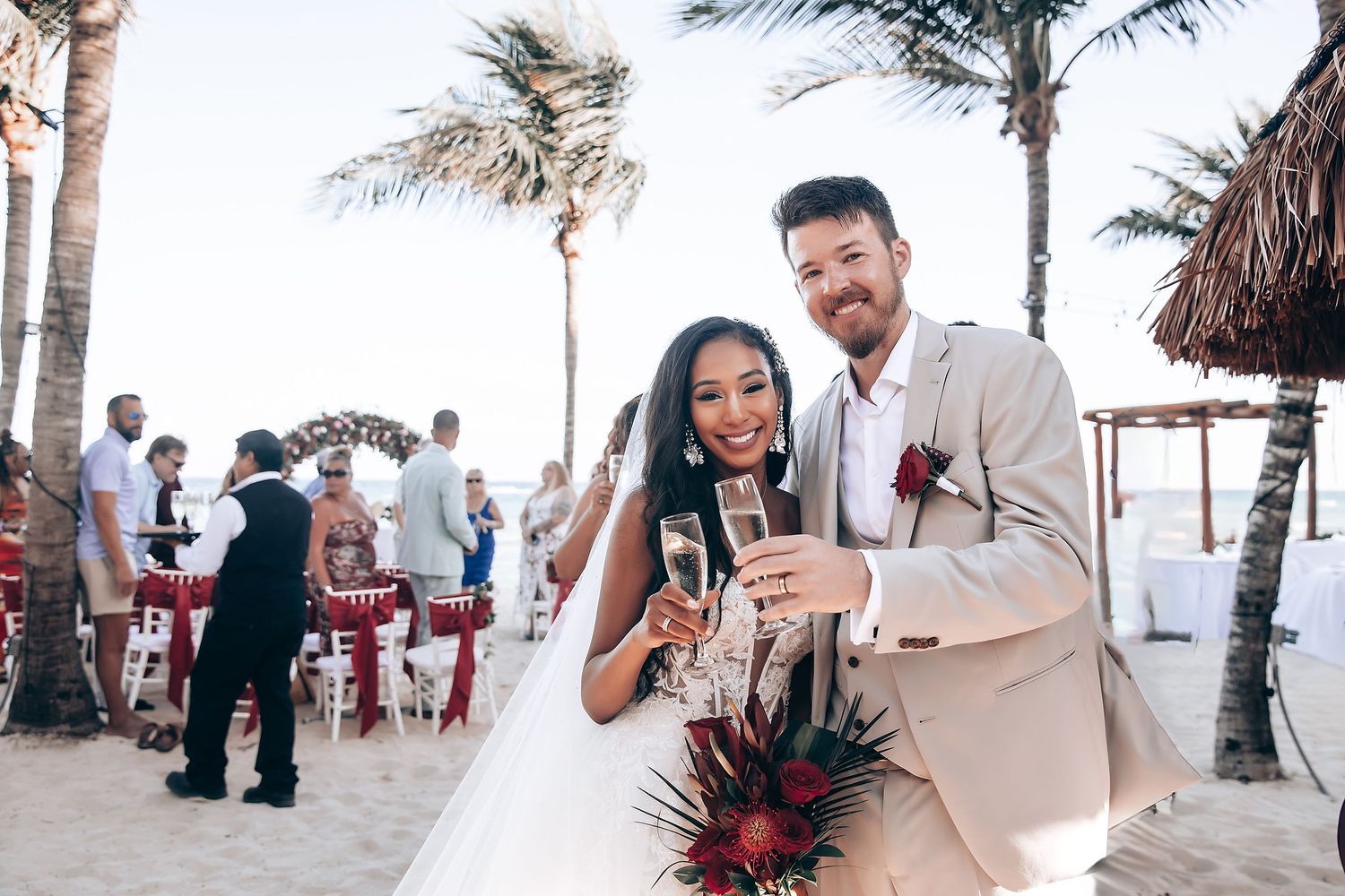 Beachside wedding celebration with palm trees swaying in the breeze as guests gather for a tropical reception.