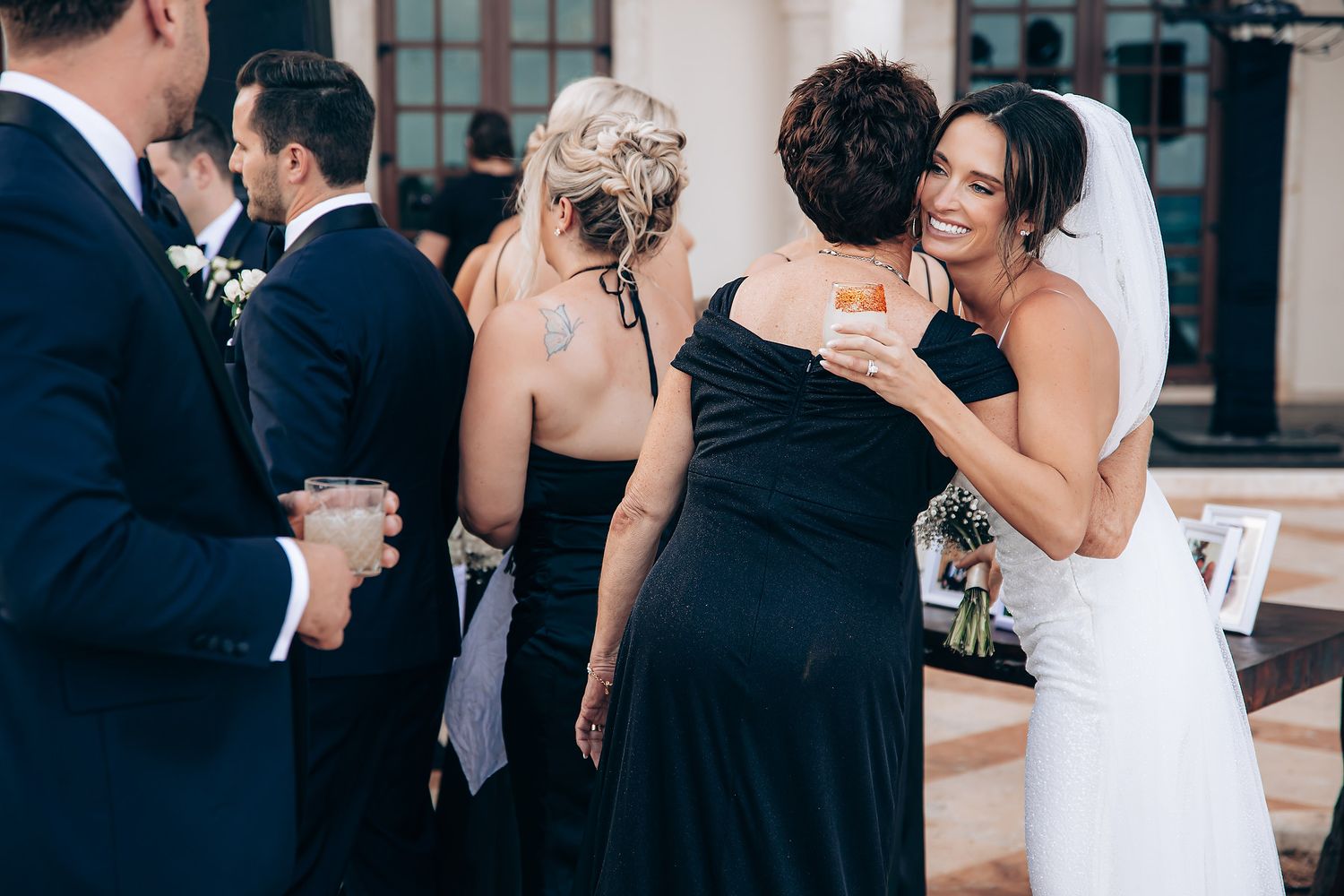 Bride and groom share an intimate dance surrounded by wedding guests at an elegant reception venue.