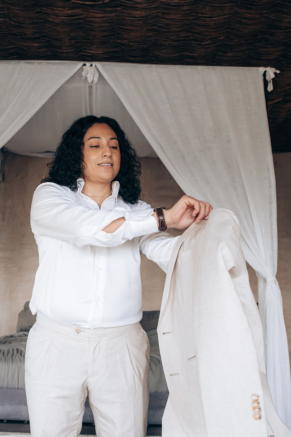 Person in white clothing lounging on white bedding in a series of relaxed poses.