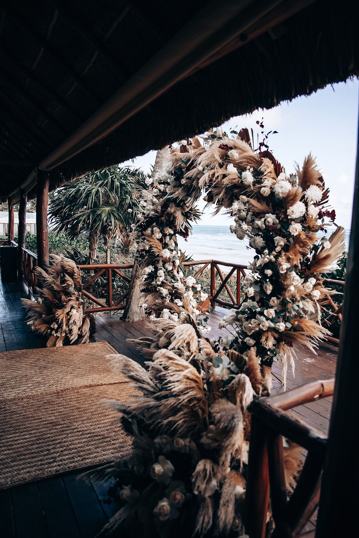 Wedding ceremony space decorated with bohemian floral installations and natural light.