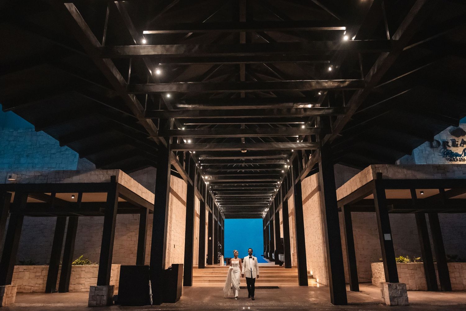 Dark industrial hallway with dramatic lighting and architectural elements.