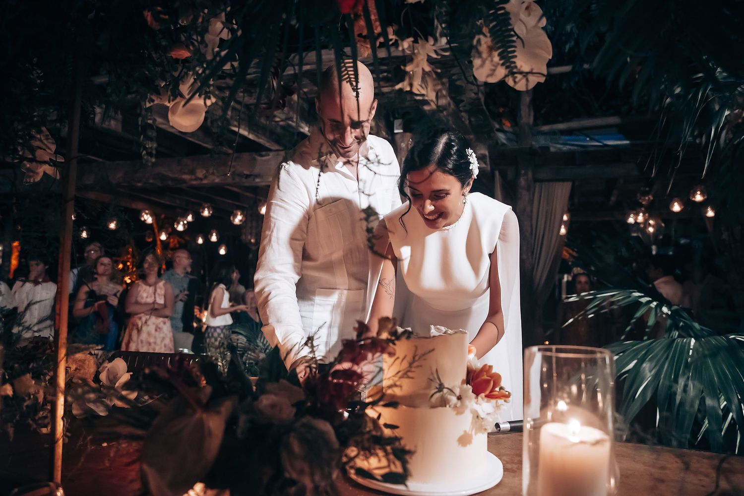 Wedding celebration at night with elegant lighting and decor.
