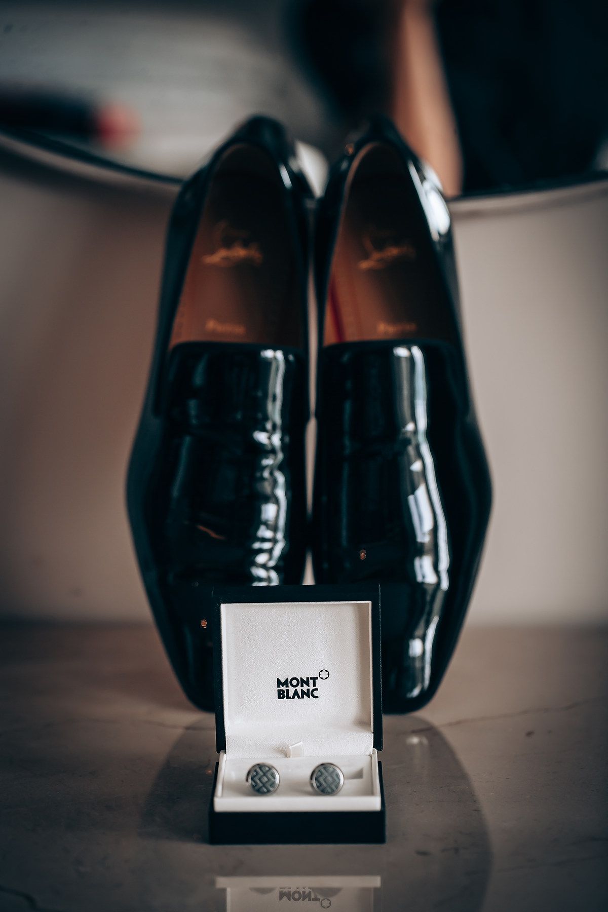 Montblanc cufflinks and box displayed on dark surface with elegant presentation.