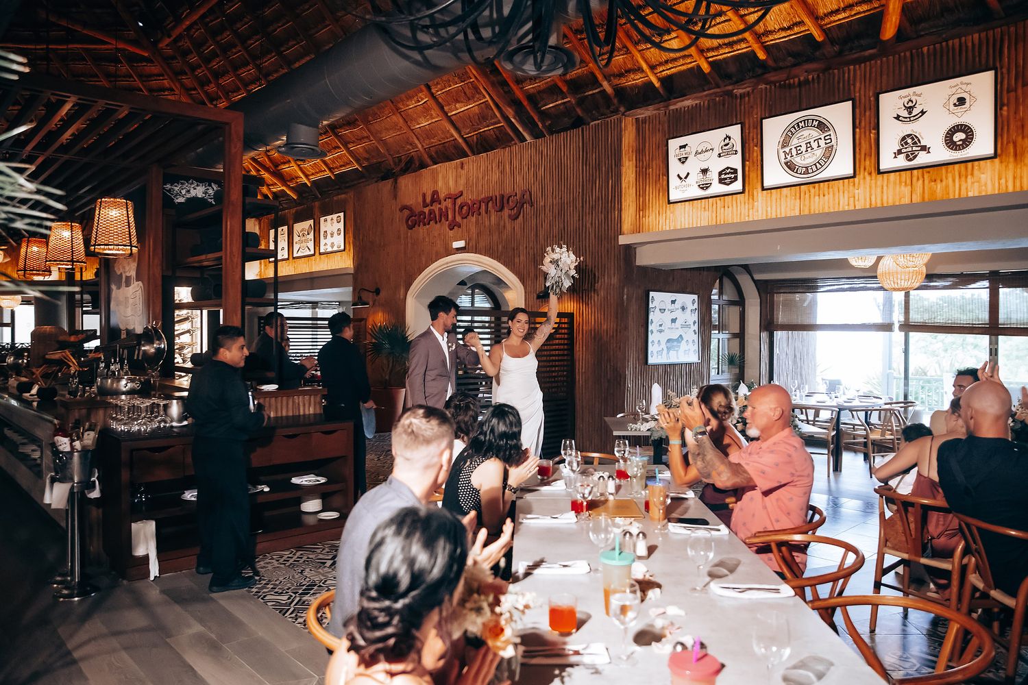 Interior of a rustic restaurant bar with warm lighting and wooden decor.