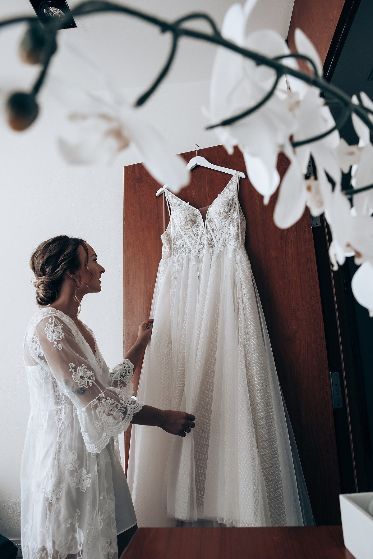 White wedding dress displayed while being prepared for the ceremony.