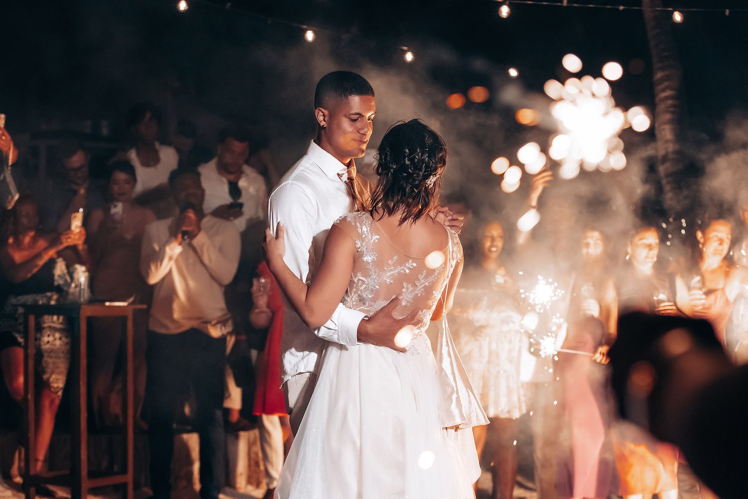Wedding reception dance floor with romantic lighting and sparklers creating a magical atmosphere.