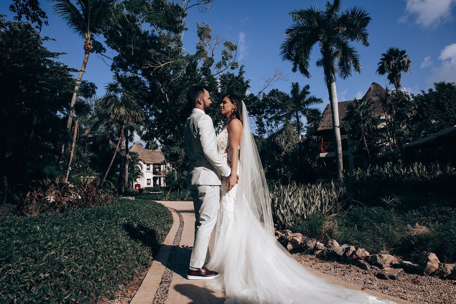 Tropical beach wedding ceremony with palm trees and ocean views.