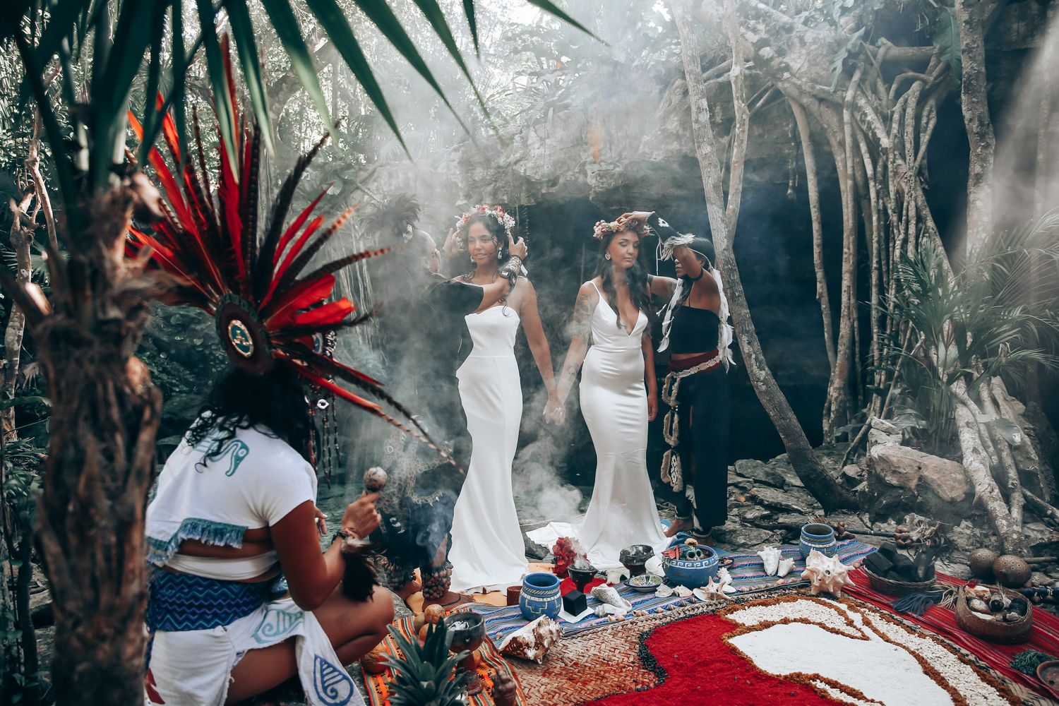 A traditional Mayan ceremony takes place in a lush jungle setting with ceremonial headdresses and white attire.