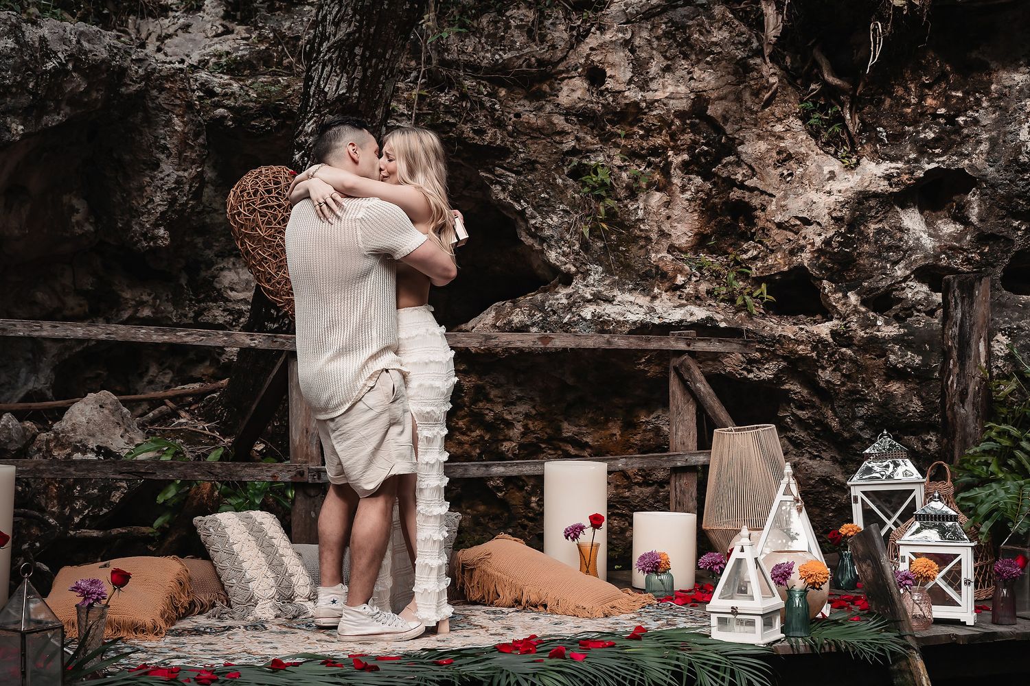 Intimate garden scene with decorative lanterns and romantic lighting against stone walls.