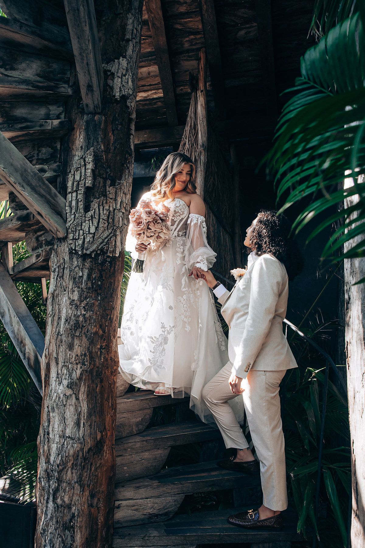 Wedding couple shares tender moments in a rustic wooden setting with natural light filtering through.