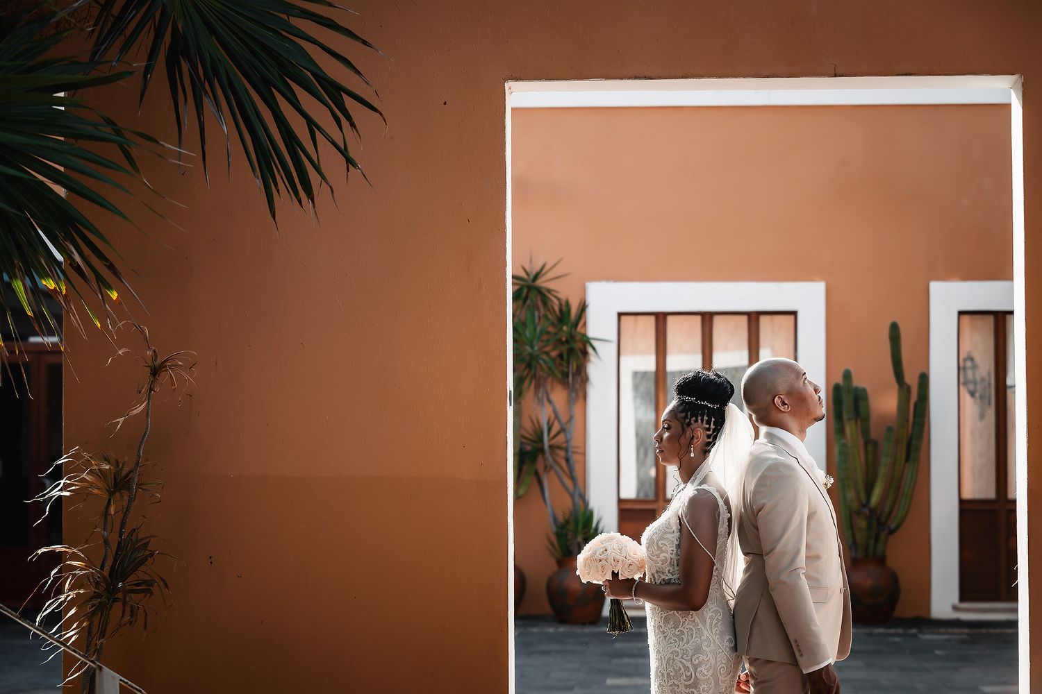 Artistic wedding photography series with terracotta walls and architectural elements.