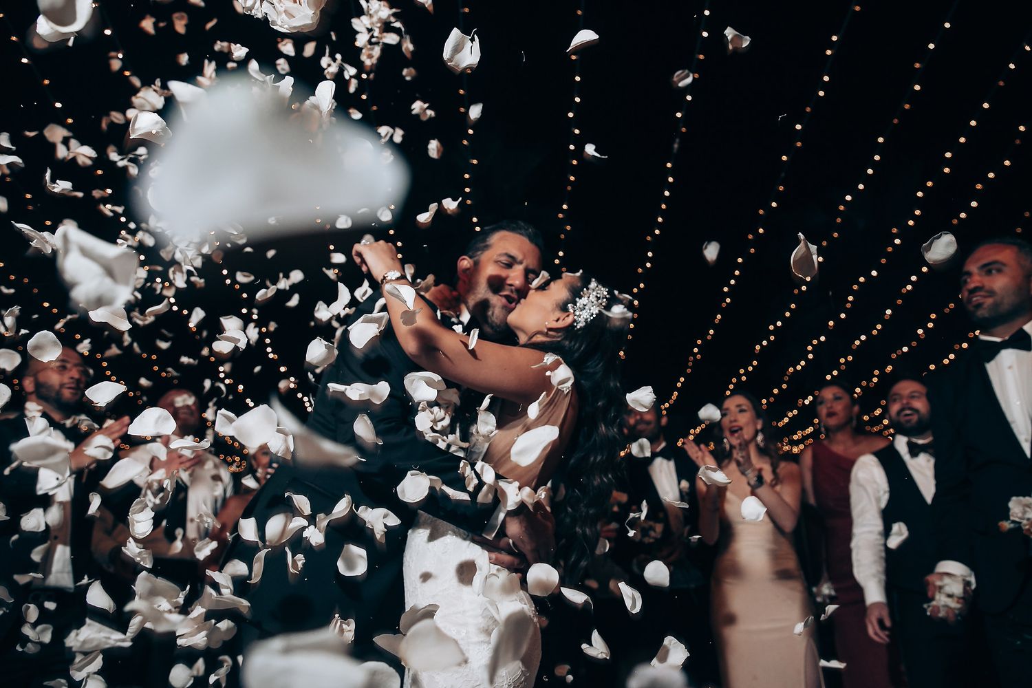Wedding celebration with confetti falling during a romantic dance moment.