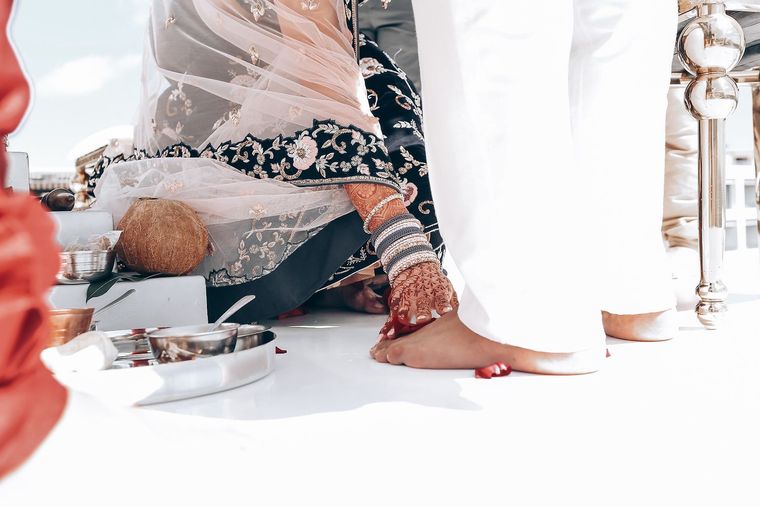 Traditional wedding ritual showing decorated feet during ceremony.