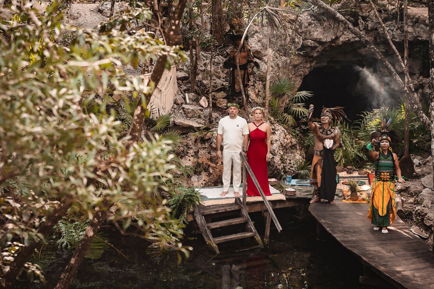Forest gathering with traditional ceremonial elements and natural decorations.