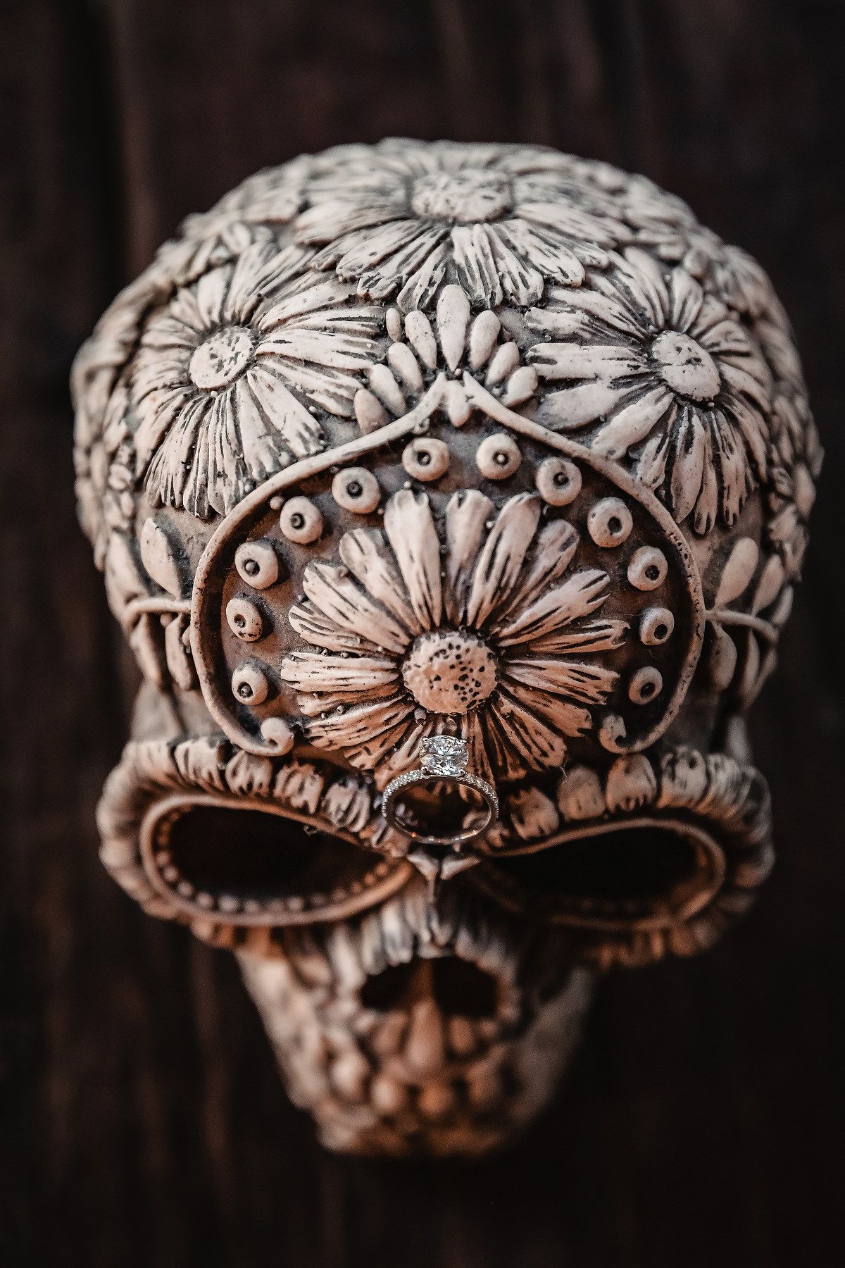 Detailed close-up shots of an ornate silver ring with floral designs and embellishments.