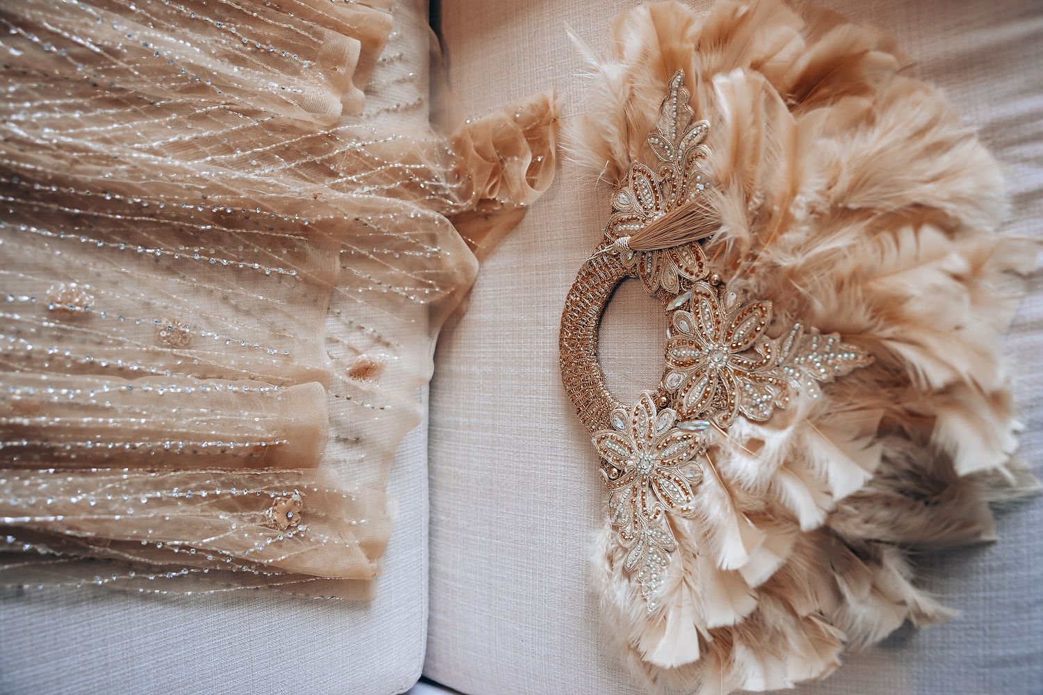 Delicate blush-colored tulle and lace fabric details from wedding attire.