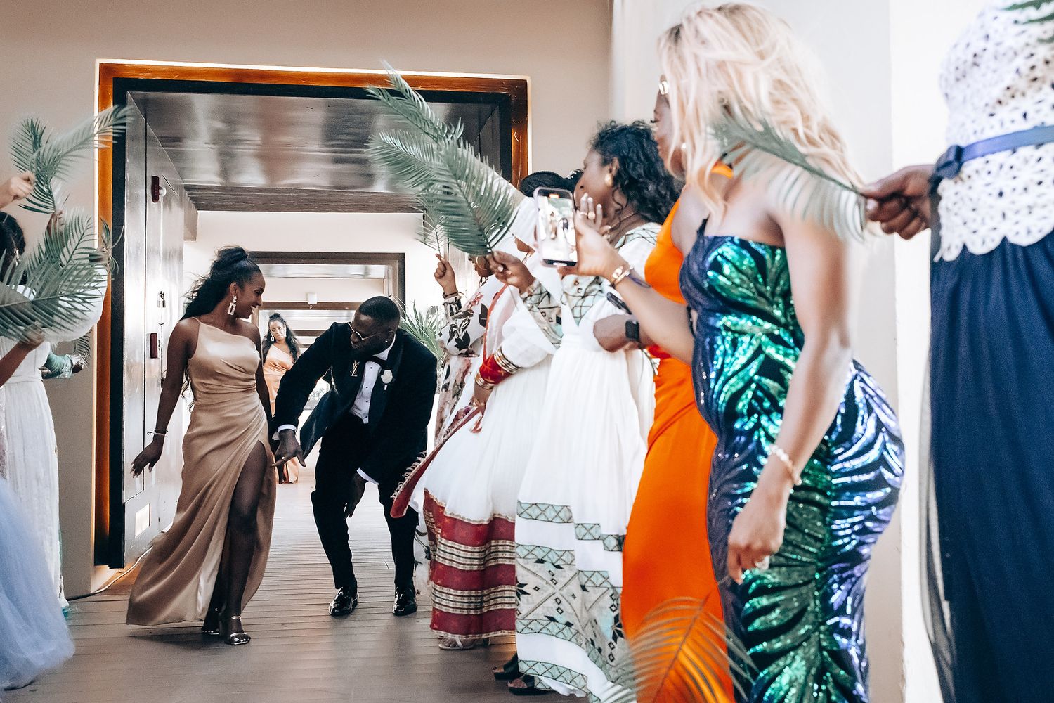 Wedding guests dancing and celebrating on a dance floor during a reception party.