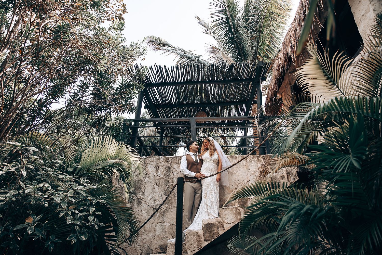 Panoramic wedding photography showing multiple poses in a tropical garden setting.