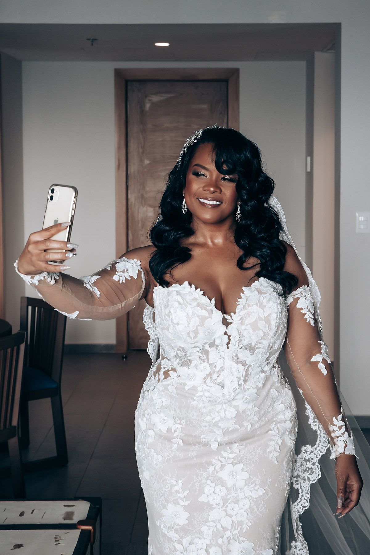 Elegant lace wedding dress with intricate details and flowing train captured in getting ready moments.