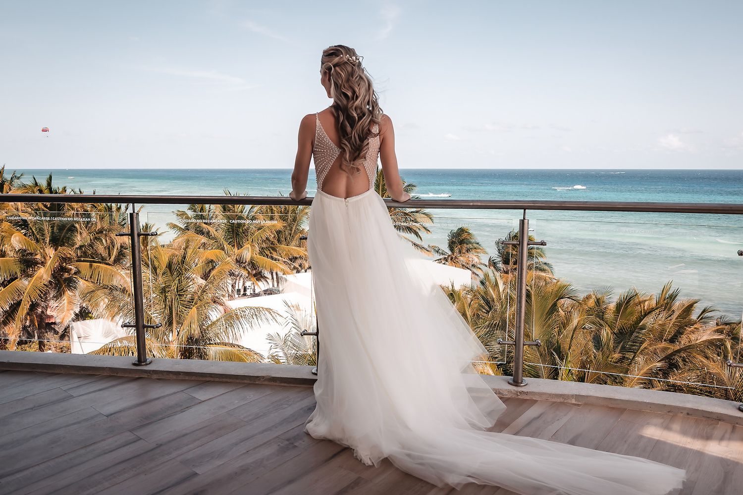 Scenic beach wedding photography with turquoise ocean and tropical palm trees.