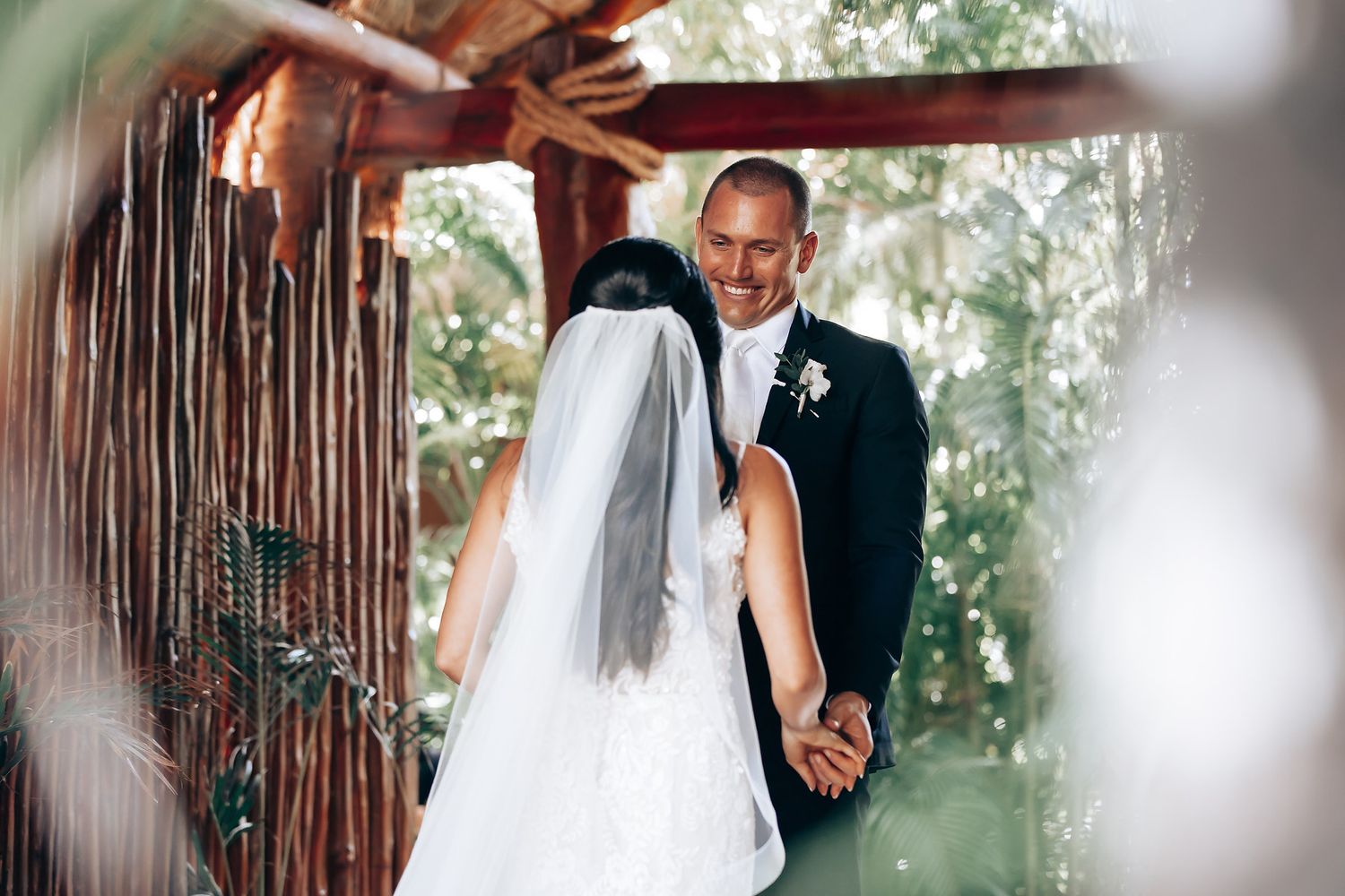 Wedding ceremony moments captured under a rustic wooden pergola with natural lighting.