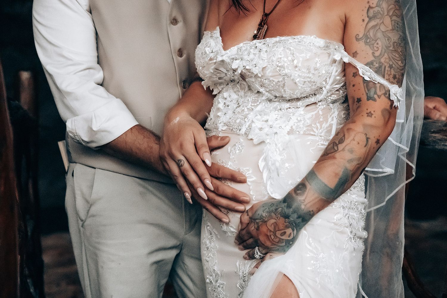 Intimate wedding portrait showing couple embracing in formal attire.