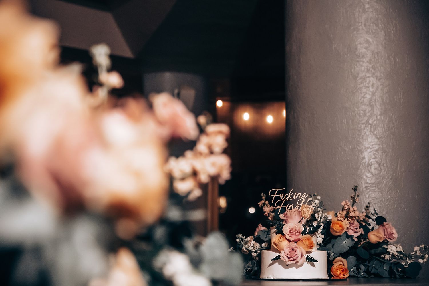 Romantic reception setting with soft lighting and floral decorations.