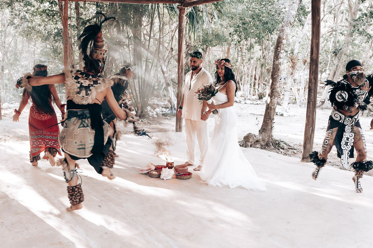Traditional dancers perform during forest wedding ceremony.