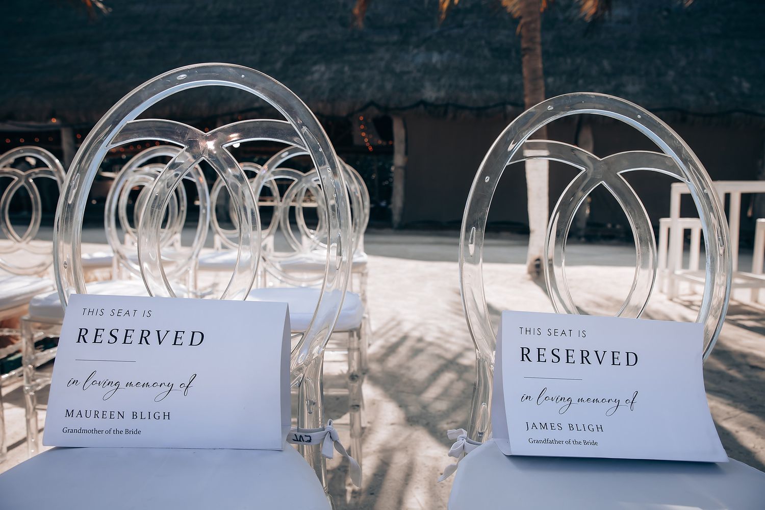 Row of white reserved signs and place cards set up for a formal event.